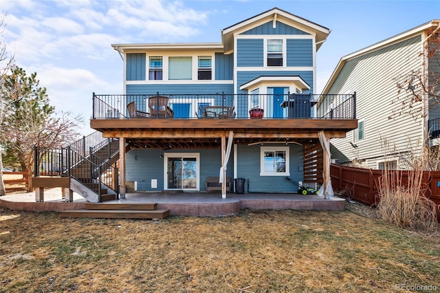 rear view of house with a patio, a deck, and fence