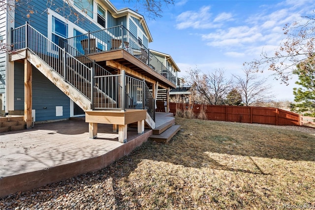 back of property with stairway and fence