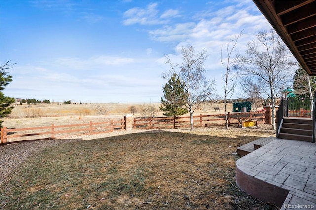 view of yard with a rural view and fence