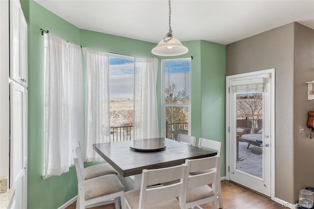 dining room with light wood-style flooring and baseboards