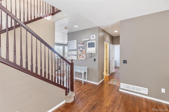 entryway featuring visible vents, baseboards, stairway, recessed lighting, and wood finished floors