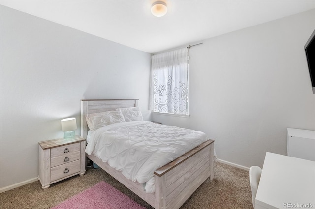 bedroom with light carpet and baseboards