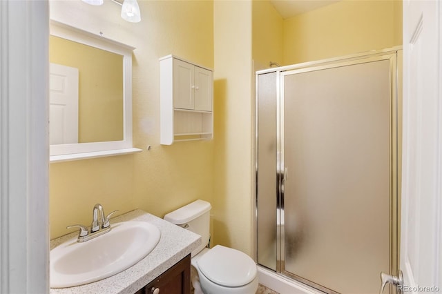 full bath with vanity, a shower stall, and toilet