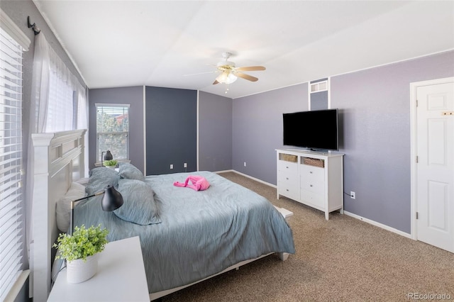 carpeted bedroom featuring baseboards, ceiling fan, and vaulted ceiling