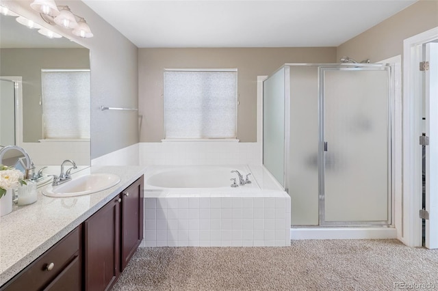 bathroom featuring a garden tub, a stall shower, and vanity