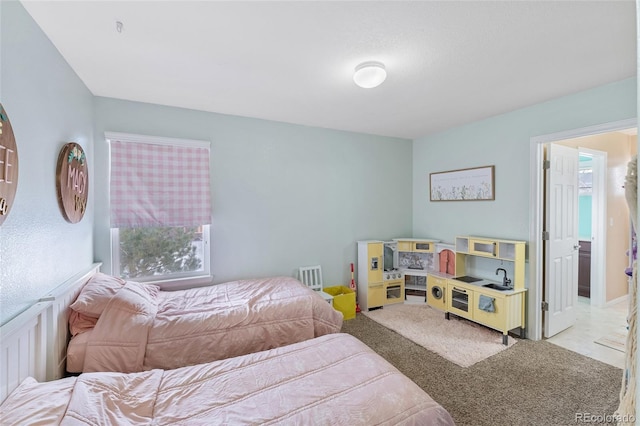 bedroom featuring light carpet