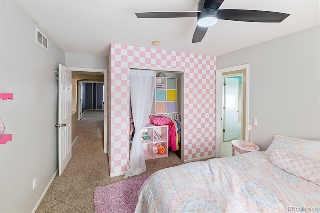 bedroom featuring a ceiling fan, visible vents, carpet, baseboards, and a closet