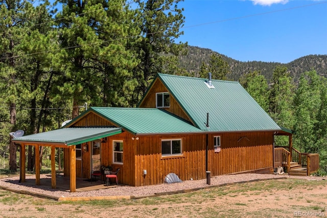546 Pulver Rd, Lake George, CO 80827 - view of side of property featuring a view of trees, a mountain view, and a metal roof