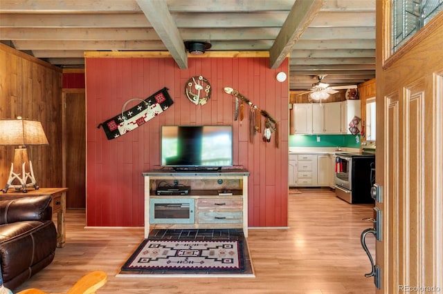 546 Pulver Rd, Lake George, CO 80827 - living room featuring beam ceiling, light wood-type flooring, wood walls, and a ceiling fan