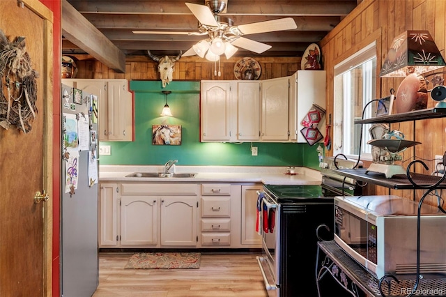 546 Pulver Rd, Lake George, CO 80827 - kitchen featuring appliances with stainless steel finishes, beam ceiling, light countertops, a ceiling fan, and light wood-style floors