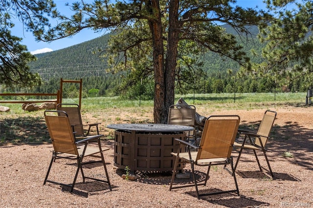 546 Pulver Rd, Lake George, CO 80827 - view of patio featuring a wooded view, a mountain view, and a fire pit