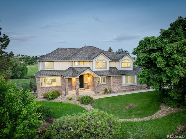 7400 S Genoa Cir, Centennial, CO 80016 - view of front of home with a front lawn, brick siding, and a porch