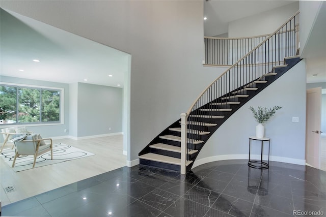 7400 S Genoa Cir, Centennial, CO 80016 - staircase with granite tiled floors, a high ceiling, and recessed lighting