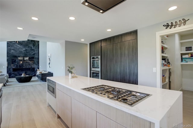 7400 S Genoa Cir, Centennial, CO 80016 - kitchen with appliances with stainless steel finishes, recessed lighting, modern cabinets, open floor plan, and light stone counters