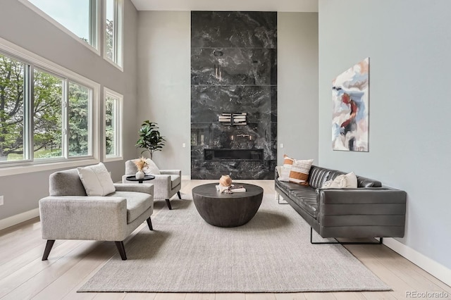 7400 S Genoa Cir, Centennial, CO 80016 - living room with wood finished floors, a high ceiling, and a fireplace