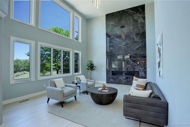 7400 S Genoa Cir, Centennial, CO 80016 - sitting room featuring healthy amount of natural light, wood finished floors, a high end fireplace, and a high ceiling