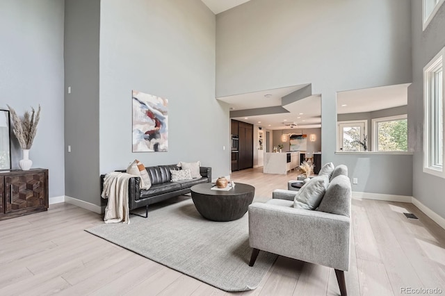 7400 S Genoa Cir, Centennial, CO 80016 - living area with a towering ceiling and light wood-style floors
