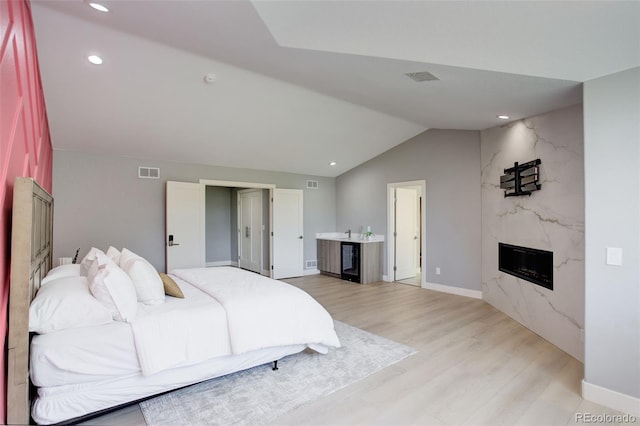 7400 S Genoa Cir, Centennial, CO 80016 - bedroom featuring a high end fireplace, light wood finished floors, lofted ceiling, and recessed lighting