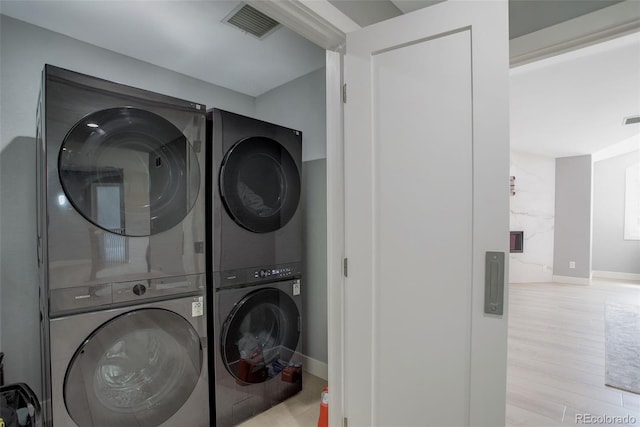 7400 S Genoa Cir, Centennial, CO 80016 - washroom with stacked washer / dryer and wood finished floors