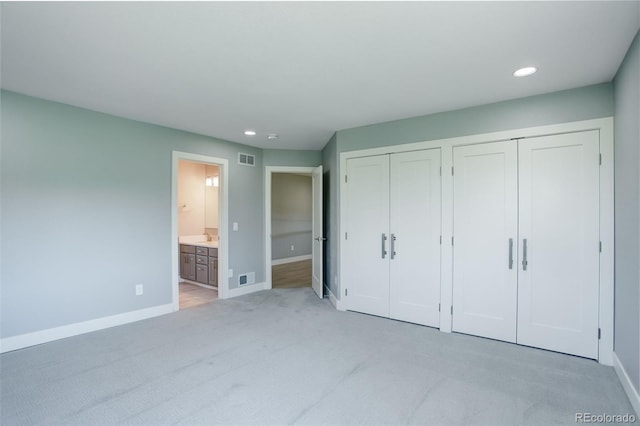 7400 S Genoa Cir, Centennial, CO 80016 - unfurnished bedroom featuring multiple closets, light colored carpet, recessed lighting, and ensuite bathroom