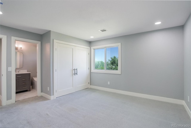 7400 S Genoa Cir, Centennial, CO 80016 - unfurnished bedroom with light colored carpet, recessed lighting, a closet, and connected bathroom