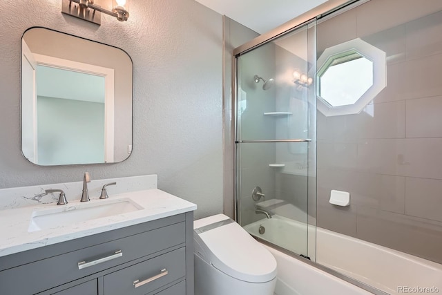 7400 S Genoa Cir, Centennial, CO 80016 - bathroom with vanity, a textured wall, and enclosed tub / shower combo