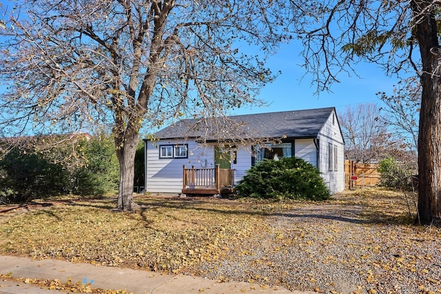 view of front of property with a deck and a front lawn