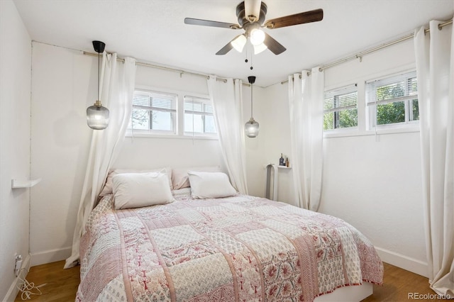 bedroom with ceiling fan and hardwood / wood-style floors