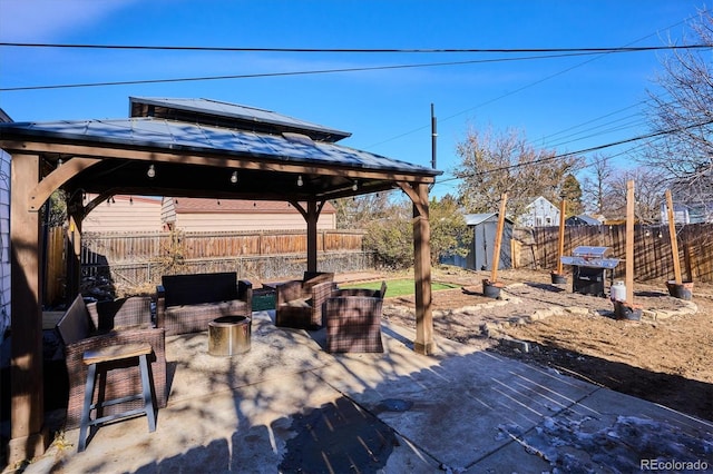 view of patio featuring a gazebo, an outdoor hangout area, and a storage unit