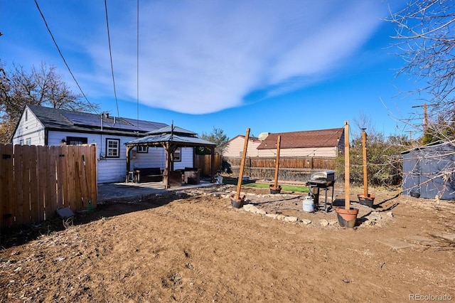 back of house with a gazebo