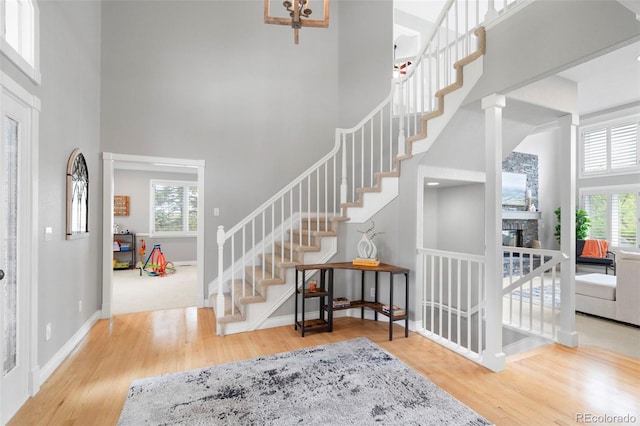 920 Shady Oak Ln, Castle Pines, CO 80108 - entrance foyer featuring a high ceiling, wood finished floors, stairway, and healthy amount of natural light
