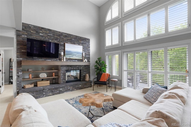 920 Shady Oak Ln, Castle Pines, CO 80108 - living area with a towering ceiling, a stone fireplace, and carpet flooring
