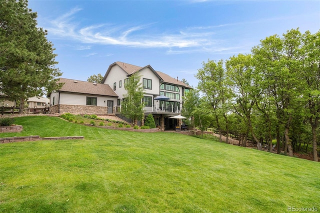 920 Shady Oak Ln, Castle Pines, CO 80108 - back of property featuring stone siding, a lawn, and a wooden deck