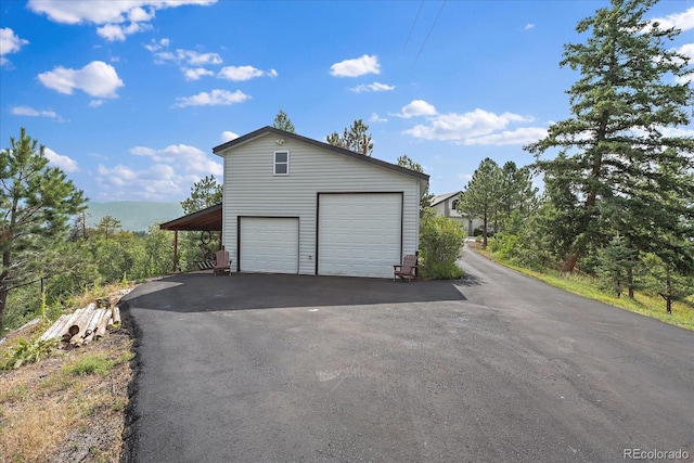 garage with aphalt driveway