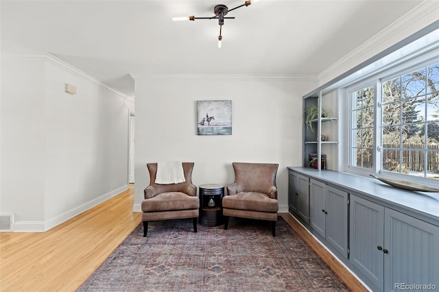 sitting room featuring crown molding and wood-type flooring