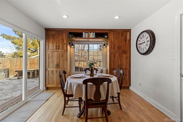 dining room with plenty of natural light and light hardwood / wood-style flooring