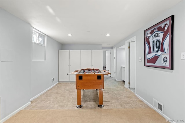 recreation room with light carpet