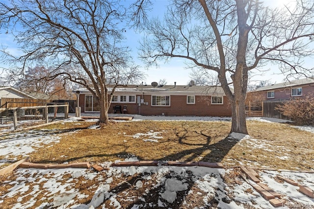 view of snow covered rear of property