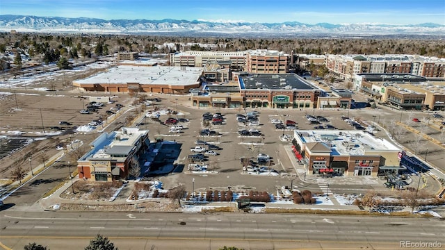 snowy aerial view with a mountain view