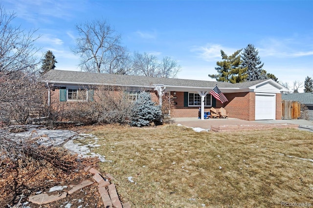 ranch-style home with a garage and a front yard