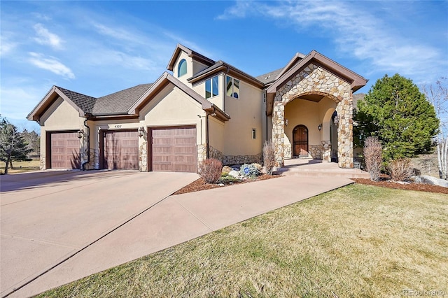 view of front facade with stucco siding, concrete driveway, an attached garage, a front yard, and stone siding