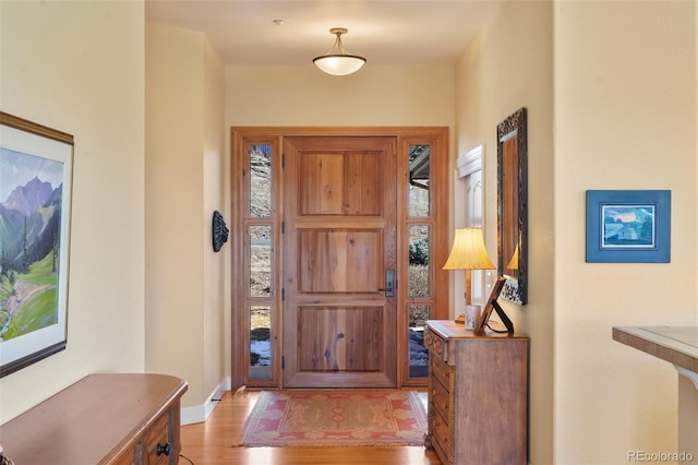 entryway featuring light wood finished floors and baseboards