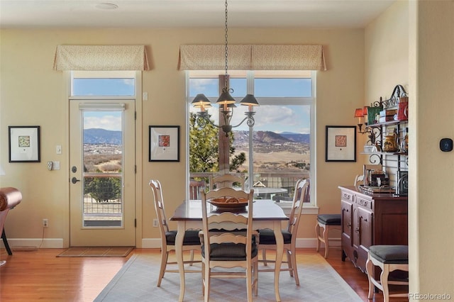 dining space with plenty of natural light, a notable chandelier, and a mountain view