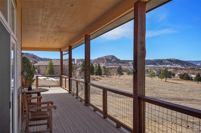 wooden deck with a mountain view