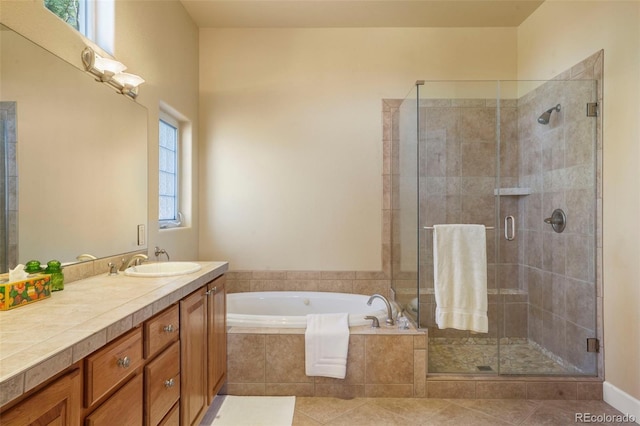 full bathroom with tile patterned flooring, a garden tub, vanity, and a shower stall