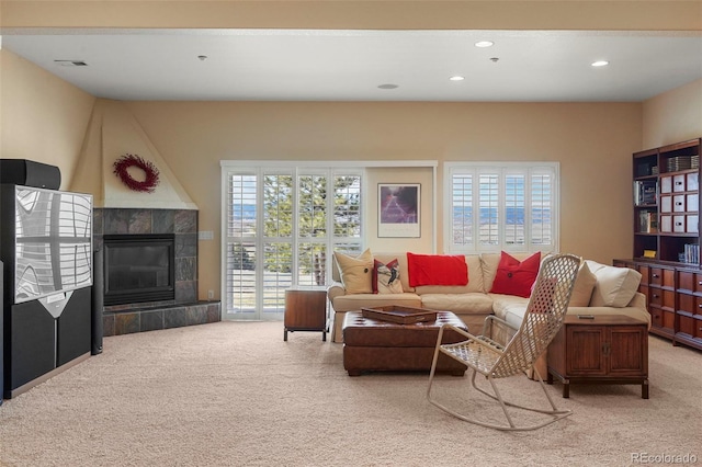 carpeted living room with recessed lighting, visible vents, and a tile fireplace