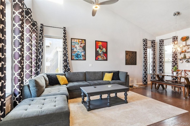 living room featuring ceiling fan, vaulted ceiling, a healthy amount of sunlight, and dark hardwood / wood-style flooring