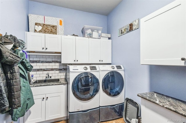 laundry area with sink, cabinets, and washer and dryer