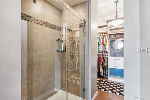 bathroom with hardwood / wood-style flooring and walk in shower