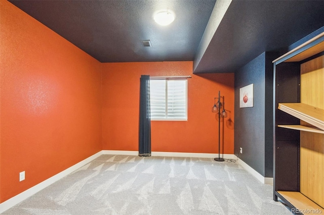 bonus room with light colored carpet